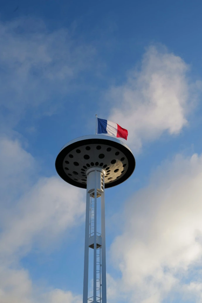a tall tower with a flag on top of it